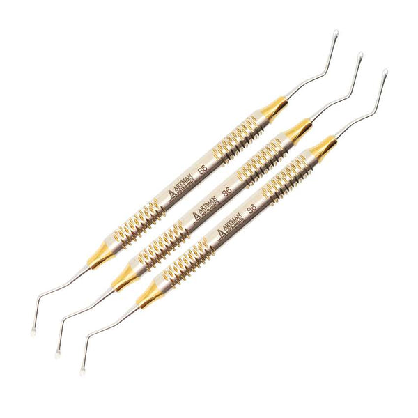 Three double-ended Hollenback dental wax carvers with ornate, gold-colored knurled handles for a secure grip.