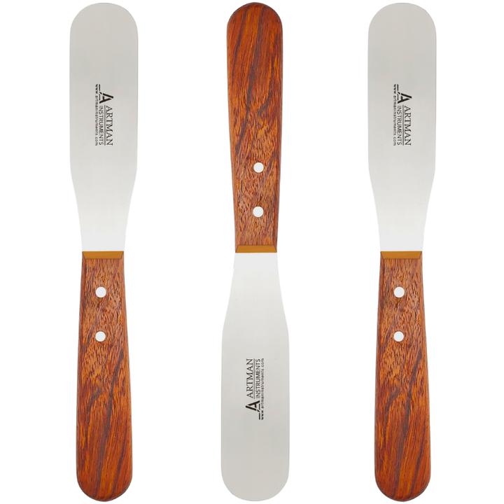 A set of six plaster spatulas with light brown wooden handles and flat metal blades, arranged for display.
